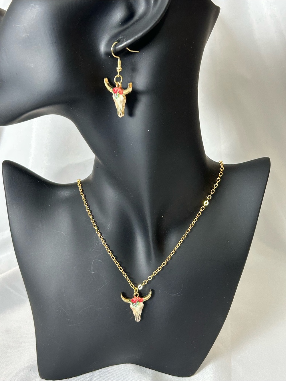 Beautiful Gold Tone Cow Skull Necklace & Earring Set. Measures 18” W/2” Ext,